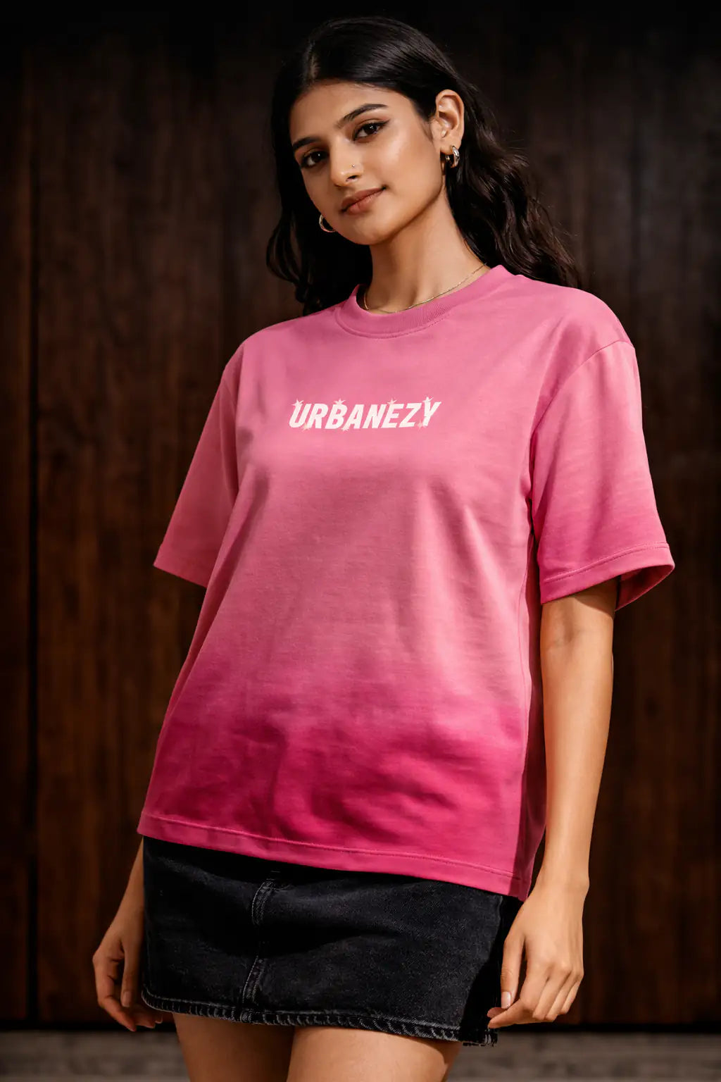 Person wearing a pink ombre t-shirt with 'URBANEZY' text against a dark background